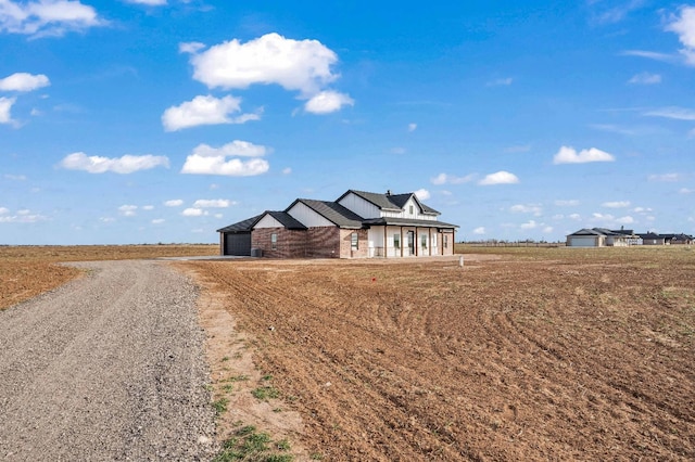 view of front facade with a rural view