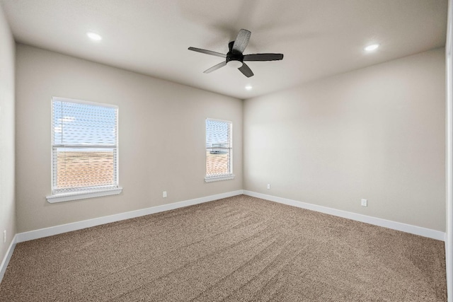 empty room with ceiling fan and carpet