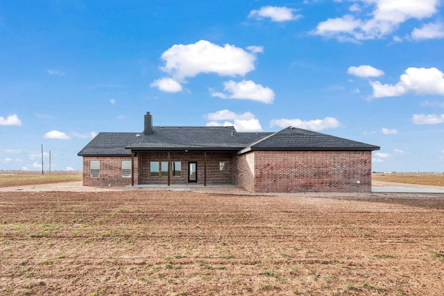 back of house with a lawn and a patio