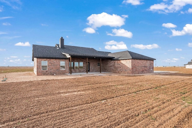 back of house with a yard and a patio area