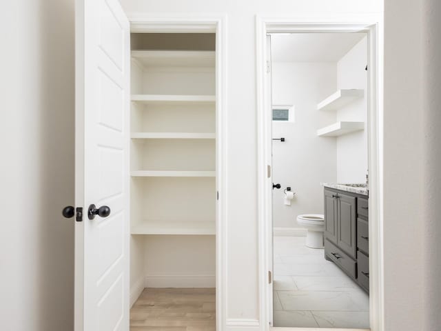 bathroom featuring vanity and toilet