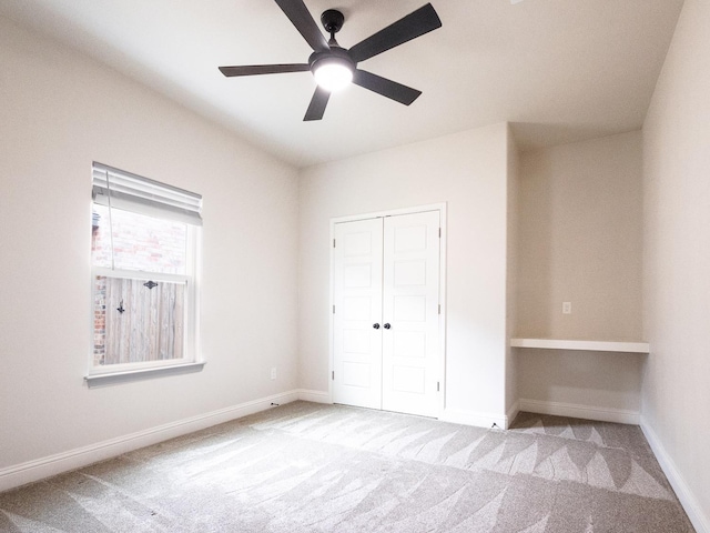 unfurnished bedroom with light carpet, a closet, and ceiling fan