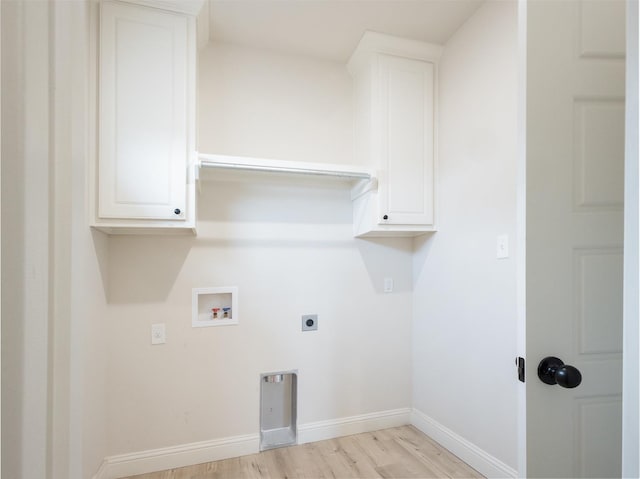 laundry area with cabinets, washer hookup, hookup for an electric dryer, and light wood-type flooring