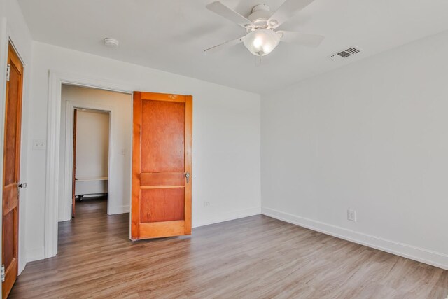 spare room with ceiling fan and light hardwood / wood-style floors