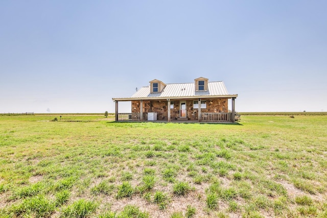 view of front of home with a rural view and covered porch