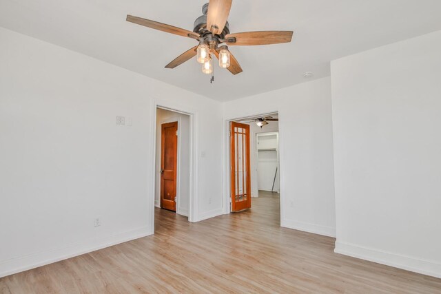 empty room with light hardwood / wood-style flooring and ceiling fan