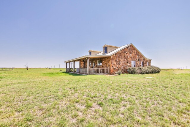 view of property exterior featuring a rural view and a yard