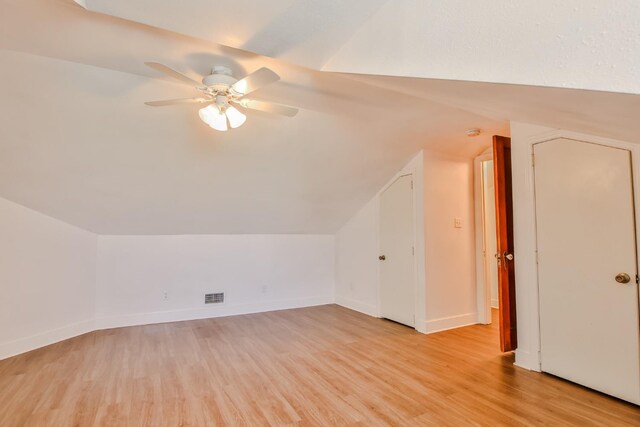 additional living space with vaulted ceiling, ceiling fan, and light hardwood / wood-style flooring