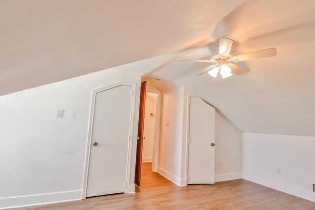 bonus room with ceiling fan, lofted ceiling, and light wood-type flooring