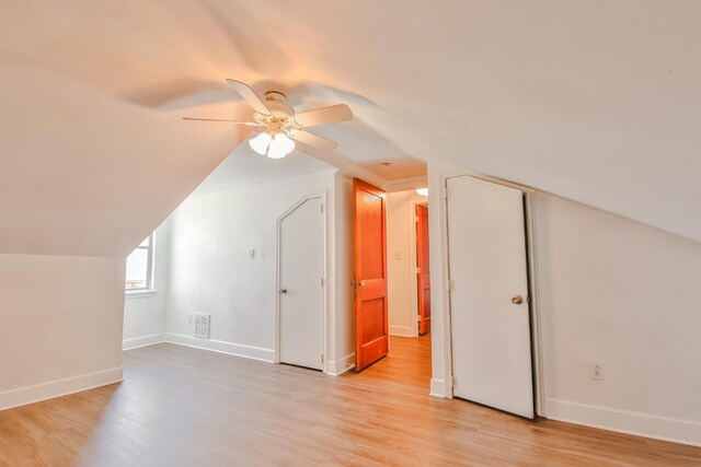 additional living space with vaulted ceiling, ceiling fan, and light wood-type flooring