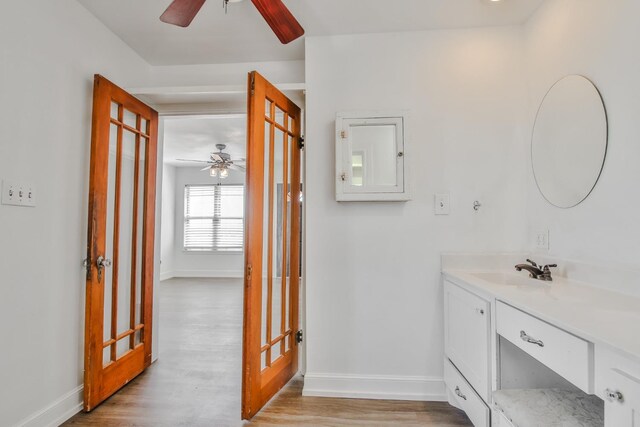 bathroom featuring vanity, hardwood / wood-style floors, and ceiling fan