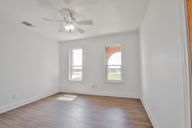 unfurnished room with ceiling fan and light wood-type flooring