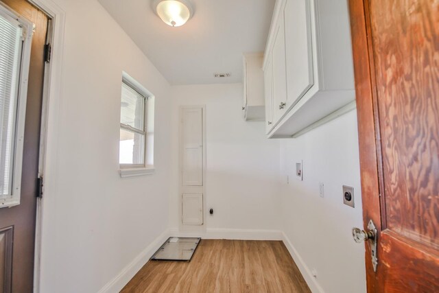 laundry room featuring cabinets, washer hookup, light hardwood / wood-style flooring, and electric dryer hookup