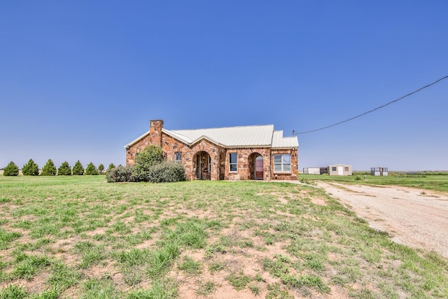 ranch-style home with a front yard and a rural view