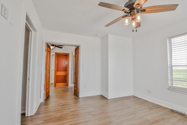 spare room with ceiling fan and light hardwood / wood-style floors