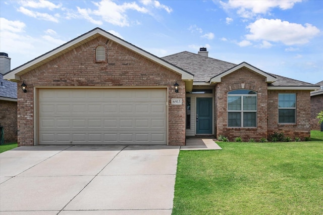 view of front of home featuring a garage and a front lawn