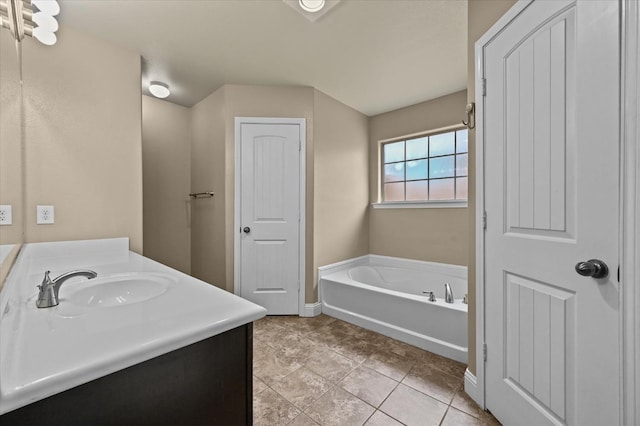 bathroom featuring vanity, a bath, and tile patterned flooring