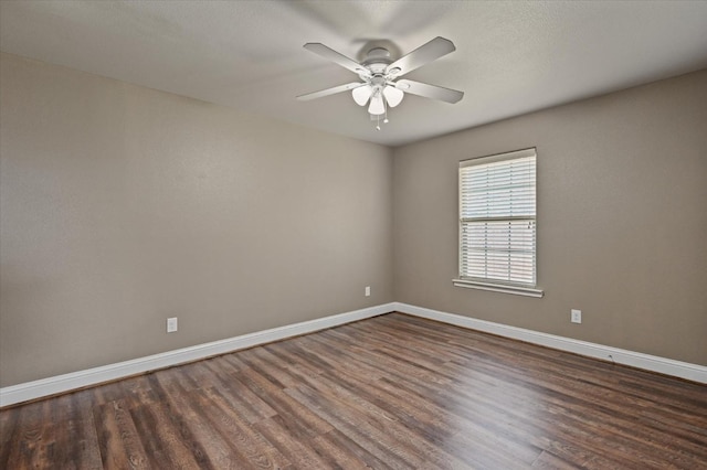 empty room with ceiling fan and dark hardwood / wood-style floors