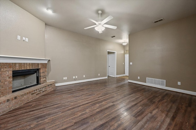 unfurnished living room with dark hardwood / wood-style floors, ceiling fan, and a fireplace