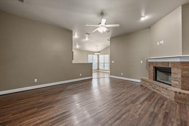 unfurnished living room featuring dark hardwood / wood-style floors, ceiling fan, lofted ceiling, and a fireplace