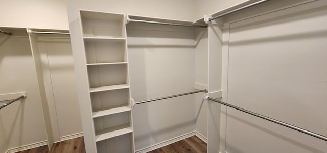 walk in closet featuring dark wood-type flooring