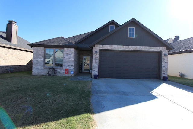 view of front of house featuring brick siding, a shingled roof, a front yard, a garage, and driveway