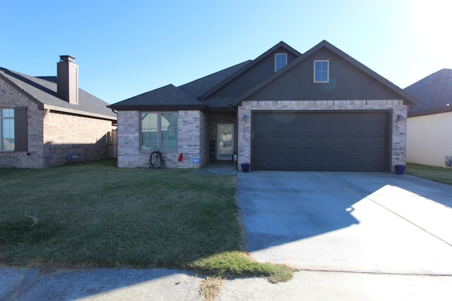 view of front of property with a garage, driveway, brick siding, and a front yard