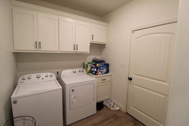 washroom featuring separate washer and dryer, wood finished floors, and cabinet space