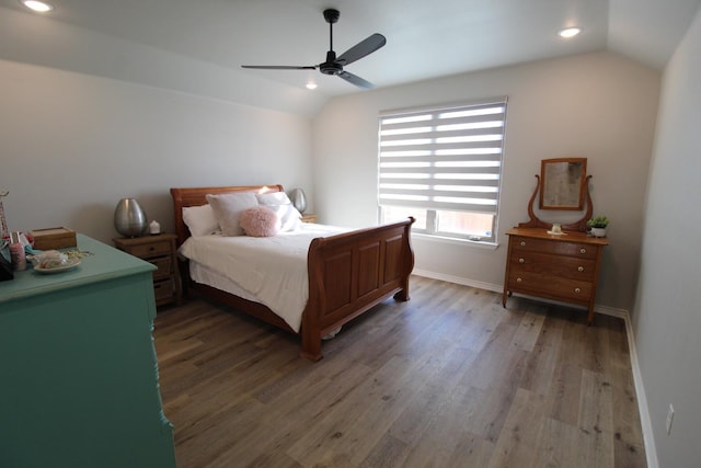 bedroom with ceiling fan, light wood-style flooring, baseboards, and vaulted ceiling