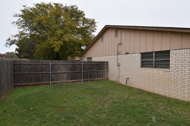 view of side of property with a lawn