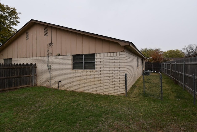 view of side of home with a lawn