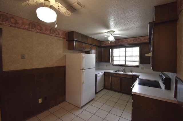 kitchen with sink, white appliances, dark brown cabinets, a textured ceiling, and ceiling fan