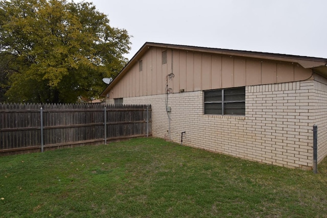 view of side of property with a lawn