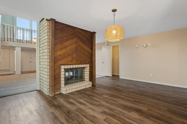 unfurnished living room featuring dark hardwood / wood-style flooring and a fireplace