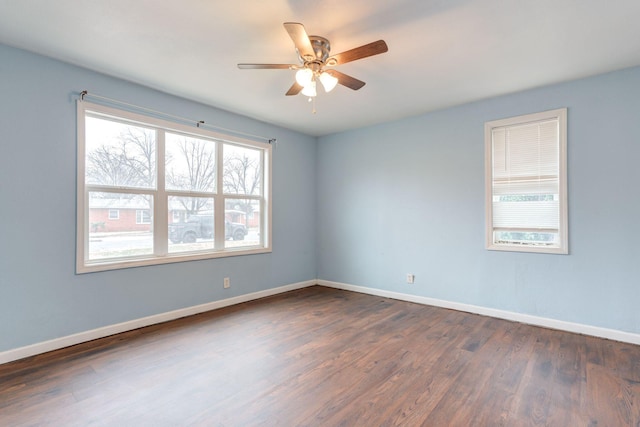 spare room with dark wood-type flooring and ceiling fan