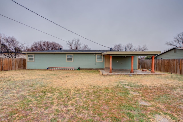 back of house featuring a patio and a lawn