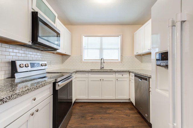 kitchen featuring sink, appliances with stainless steel finishes, light stone counters, white cabinets, and dark hardwood / wood-style flooring