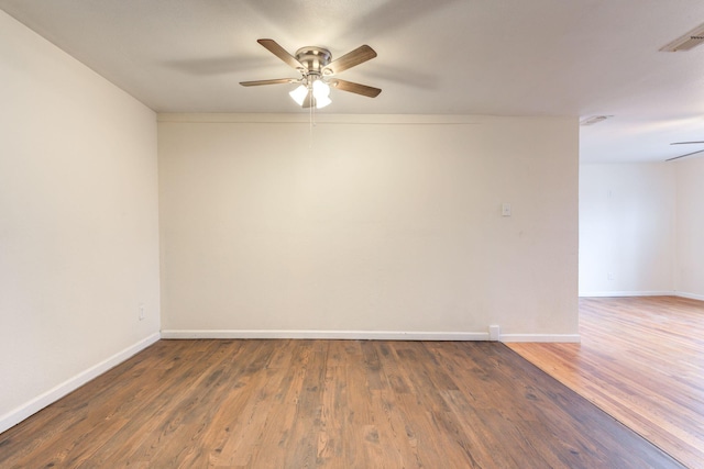 unfurnished room featuring dark hardwood / wood-style floors and ceiling fan