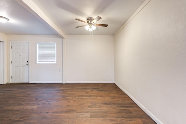 empty room featuring dark wood-type flooring and ceiling fan