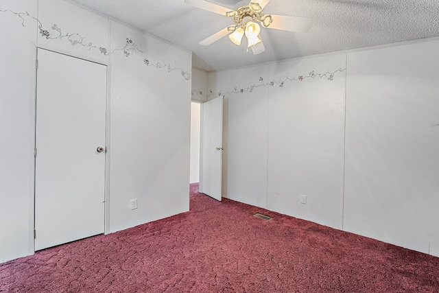 unfurnished bedroom with ceiling fan, carpet floors, and a textured ceiling