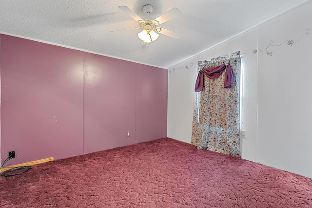 spare room featuring ceiling fan, carpet floors, and a textured ceiling