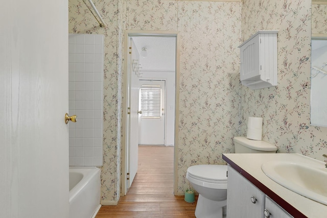 full bathroom with vanity, toilet, bathing tub / shower combination, and hardwood / wood-style floors