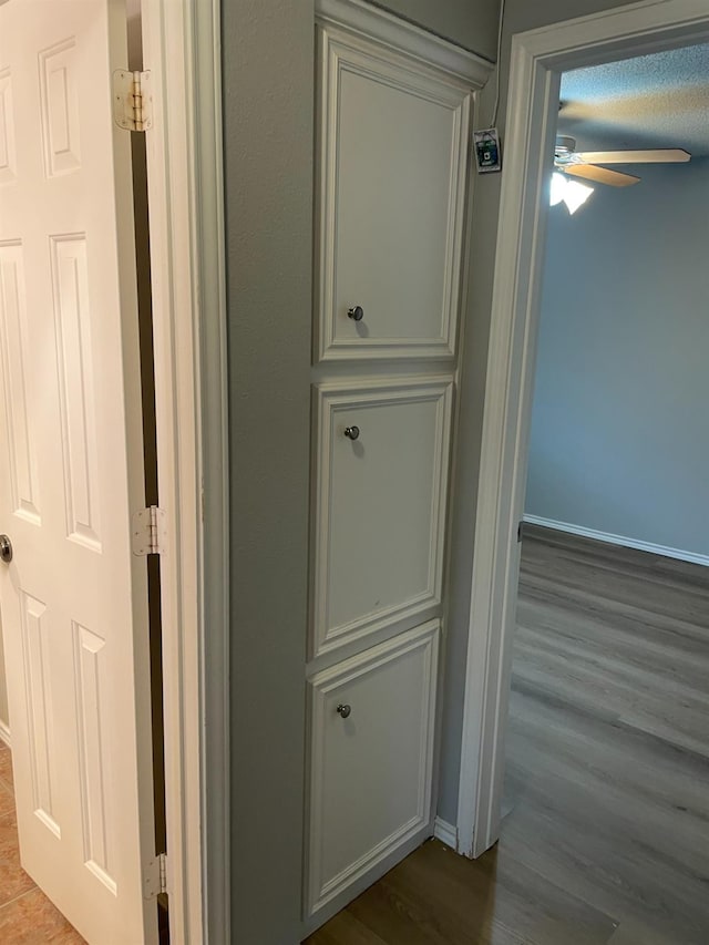 hallway with hardwood / wood-style flooring