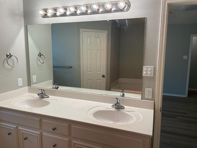 bathroom featuring vanity and a tub