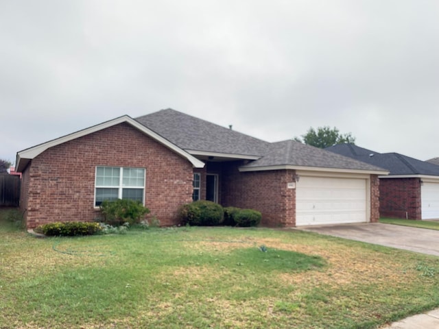 single story home featuring a garage and a front lawn