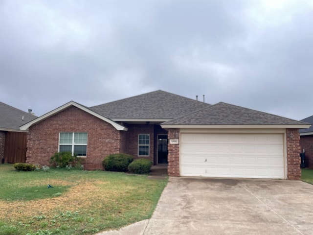 ranch-style home featuring a garage and a front yard