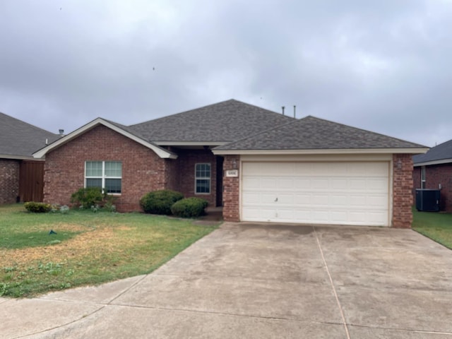 ranch-style home with a garage and a front yard