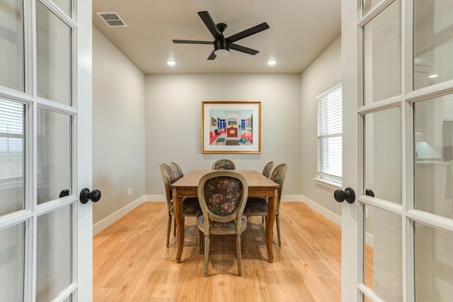 dining area with french doors, ceiling fan, and light hardwood / wood-style flooring