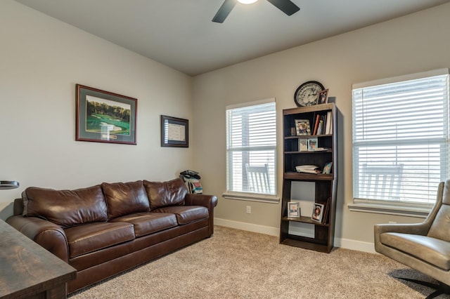 living room with light colored carpet and ceiling fan