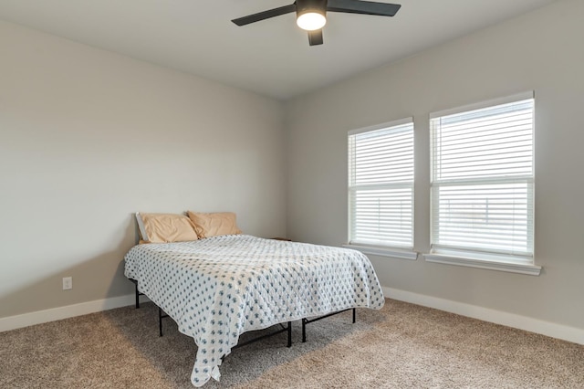 bedroom featuring light colored carpet and ceiling fan